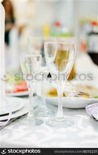 Banquet wedding table setting with plate and wineglass or glass. table setting with plate and wineglass or glass