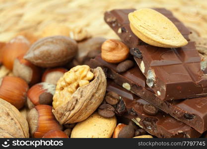 bar of chocolate and nuts on a wicker mat