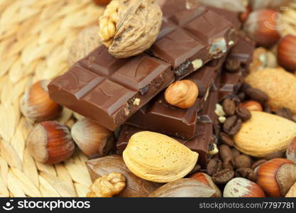 bar of chocolate and nuts on a wicker mat