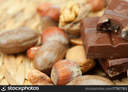 bar of chocolate and nuts on a wicker mat