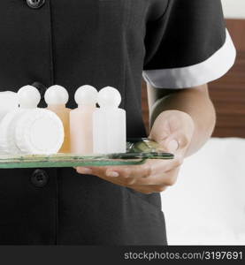 Bar Of Soap, Bedroom, Close-Up, Color Image, Focus On Foreground, Front View, Holding, Hotel Room, Human Hand, Indoors, Midsection, Moisturizer, One Person, Part Of, Photography, Square, Uniform, Assistance, Preparation, Room Service, Service, Hospitality