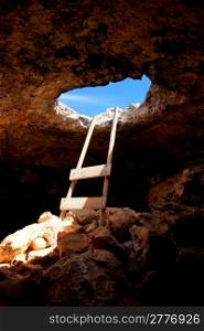 Barbaria cape cave hole with rustic ladder on wood and the light in out hole