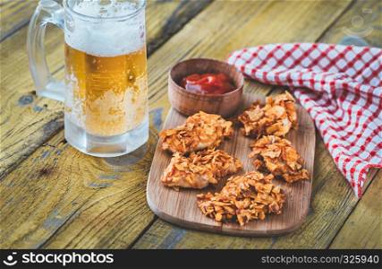 Barbecue chicken bites with mug of beer