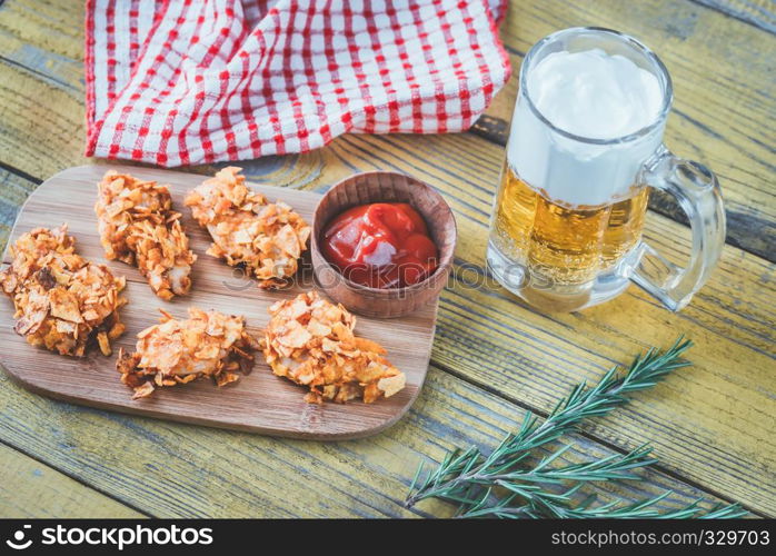 Barbecue chicken bites with mug of beer