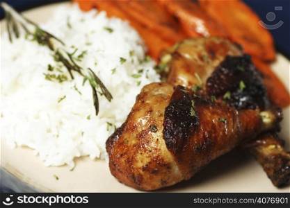 Barbecue chicken meal with rice and carrots