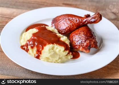 Barbecue duck legs with mashed potato close-up