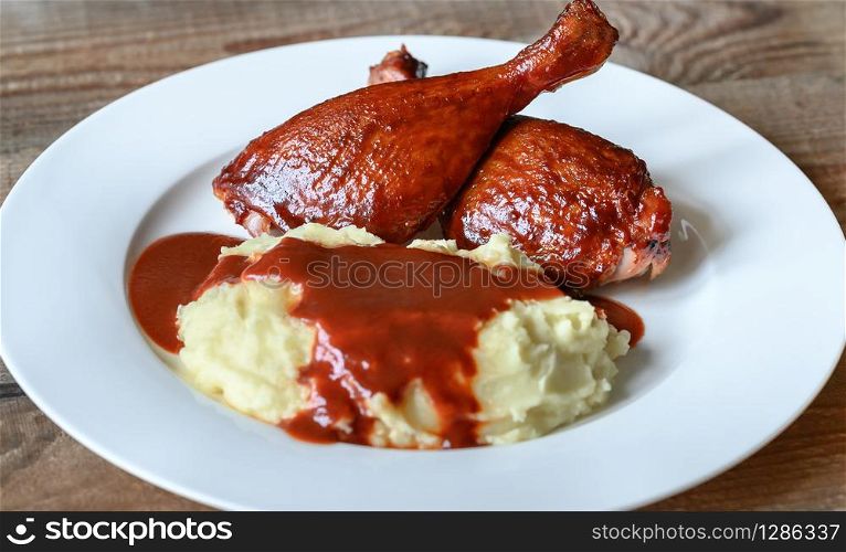 Barbecue duck legs with mashed potato close-up