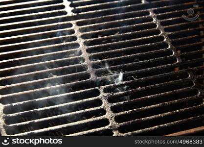 Barbecue grill texture with coal smoke macro detail