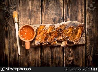 Barbecue pork ribs with spicy sauce. On a wooden table.. Barbecue pork ribs with spicy sauce.