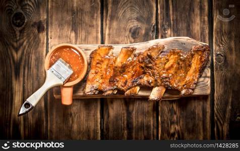 Barbecue pork ribs with spicy sauce. On a wooden table.. Barbecue pork ribs with spicy sauce.