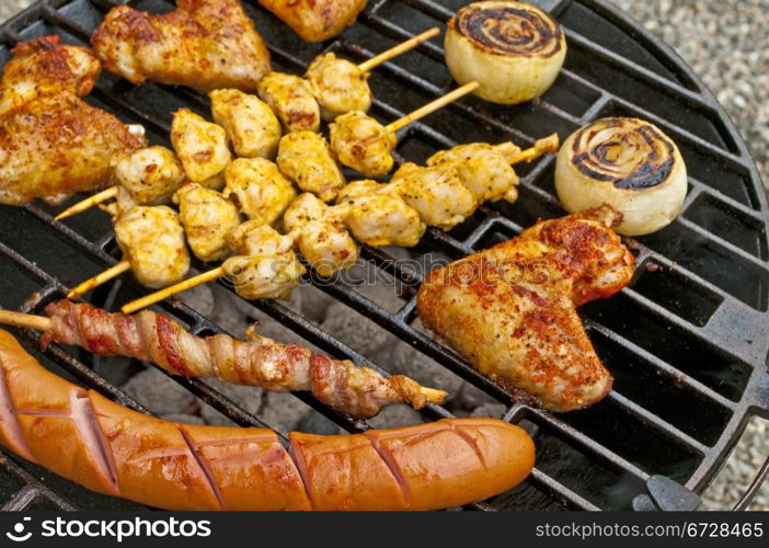 barbecue with chicken wings,Bratwurst, meat skewer and ham