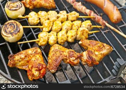 barbecue with chicken wings,Bratwurst, meat skewer and ham