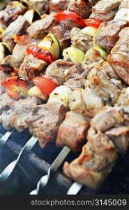 Barbecue with delicious grilled meat and onions on grill