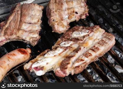 Barbecue with grilled pork ribs, beef and criollo sausage. Spanish churrasco