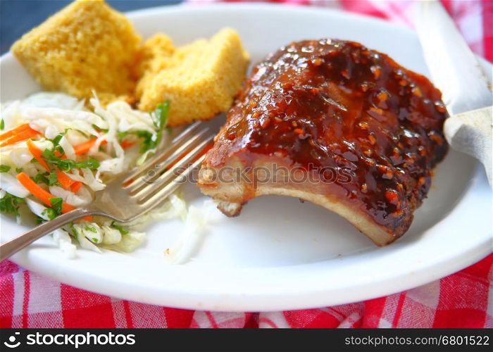 Barbecued baby back ribs with coleslaw and cornbread