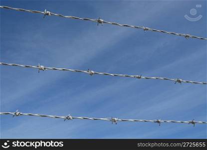 Barbed wire against a blue sky