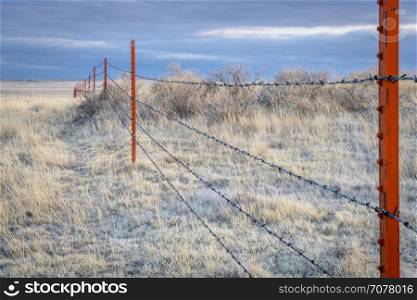 Barbed wire fence in Pawnee National Grassland at winter dusk
