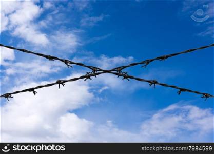 Barbed wire on blue sky