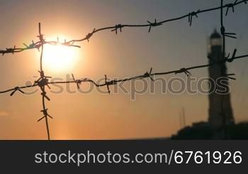 Barbed wire silhouette in sunset