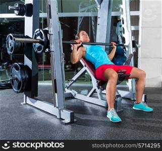 Barbell Incline Bench Press woman in multipower Smith machine workout at gym