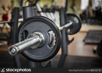 Barbell ready to workout, indooors, shallow DOF