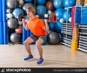 barbell squats blond man at gym exercise workout