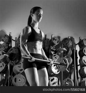 Barbell woman workout fitness club at weightlifting gym