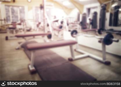 Barbellon stand in gym with exercise equipment shot with blur. Barbellon stand in gym shot with blur