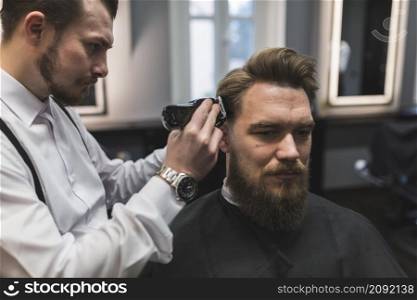 barber shaving temples man