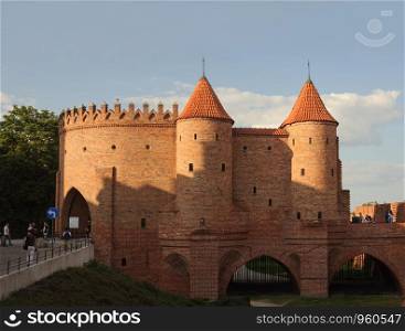 Barbican (16th century city fortification) and city walls in old town of Warsaw, Poland