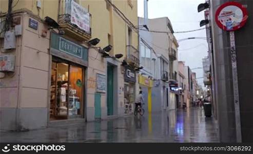 BARCELONA - AUGUST 21, 2012: Busy street after the rain. People crowd. Timelapse with impressionism mood.