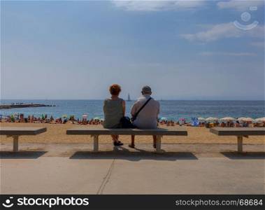 Barcelona. City Beach.. People rest on a sandy beach in the area Pablenou. Barcelona. Spain.