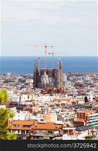 Barcelona city view with Sagrada Familia cathedral and Mediterranean Sea.