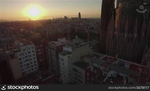 BARCELONA, SPAIN - JULY 27, 2016: Aerial panorama of city with Sagrada Familia at sunset. Roman Catholic is under construction from 1882