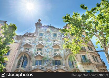 BARCELONA, SPAIN - May 21, 2016: Facade of Casa Mila with bright sun on the street of Barcelona, Spain. Famous building designed by Antoni Gaudi, included in the UNESCO list. Facade of Casa Mila in Barcelona