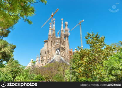 BARCELONA SPAIN - May 21 2016 La Sagrada Familia - View from the green park to the cathedral designed by Antonio Gaudi, which is still under construction at May 21, 2016 in Barcelona, Spain.