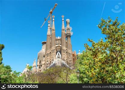 BARCELONA SPAIN - May 21 2016 La Sagrada Familia - View from the green park to the cathedral designed by Antonio Gaudi, which is still under construction at May 21, 2016 in Barcelona, Spain.. View from the green park to Sagrada Familia