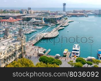 Barcelona. The building of the port.. The building of the port and the boats in the harbor of Barcelona.