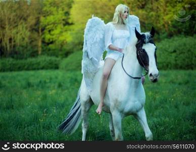 Bare feet woman - angel riding a horse