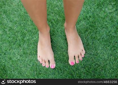 Bare feet woman stepping on the grass