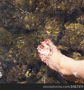 Bare foot in stream of water