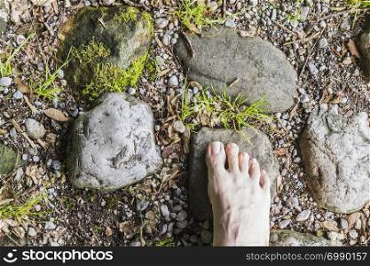 Barefoot aerial view on stone surface in the forest