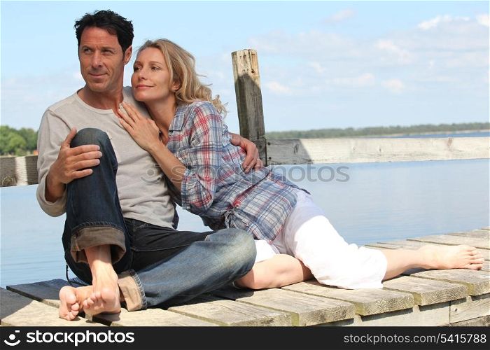 Barefoot couple by the water