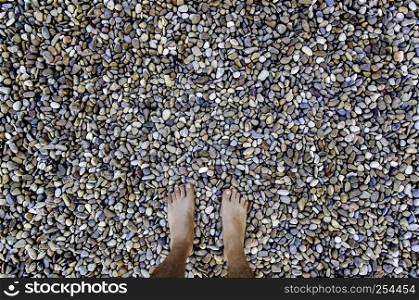 Barefoot feet on a stones, detail of relaxation, spa and zen