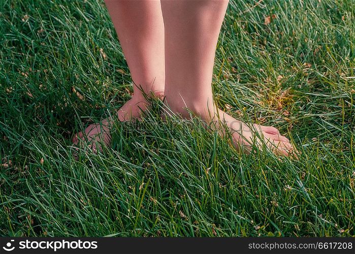 Barefoot Girl Standing On Grass. Nature Health Energy Concept. Copyspace On Forefround.. Nature Health Energy Concept, Barefoot Girl Standing On Grass