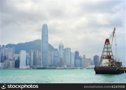 Barge in front of business district in Hong Kong. Some 456,000 vessels arrived in and departed from Hong Kong during the year, carrying 243 million tonnes of cargo
