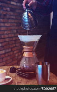 Barista brewing coffee. Barista brewing coffee in chemex in the cafe