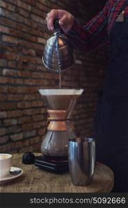 Barista brewing coffee. Barista brewing coffee in chemex in the cafe