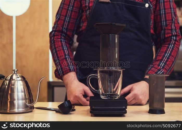 Barista brewing coffee in aeropress in the cafe. Barista brewing aeropress coffee