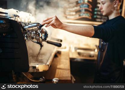Barista hand pours beverage from coffee machine. Professional espresso preparation by bartender. Barista hand pours beverage from coffee machine
